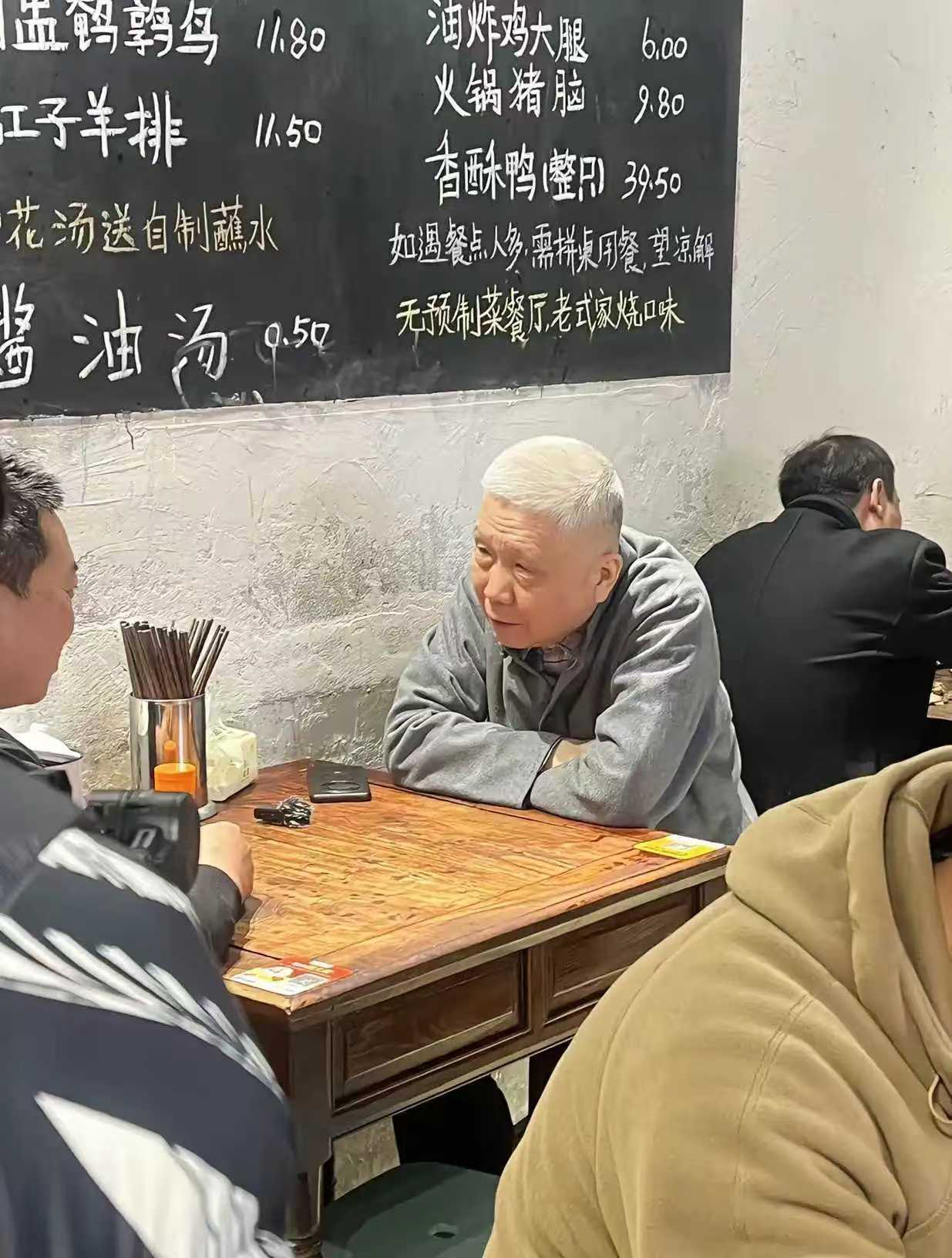 这老头估计是看上这张桌子了